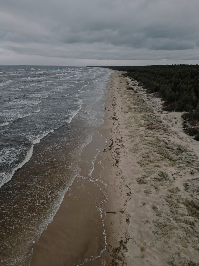 Mastering the First Impression: Your intriguing post title goes here A breathtaking aerial view of the Baltic Sea shoreline in Kalngale, Latvia, on a cloudy winter day.